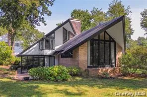 a front view of house with yard and green space