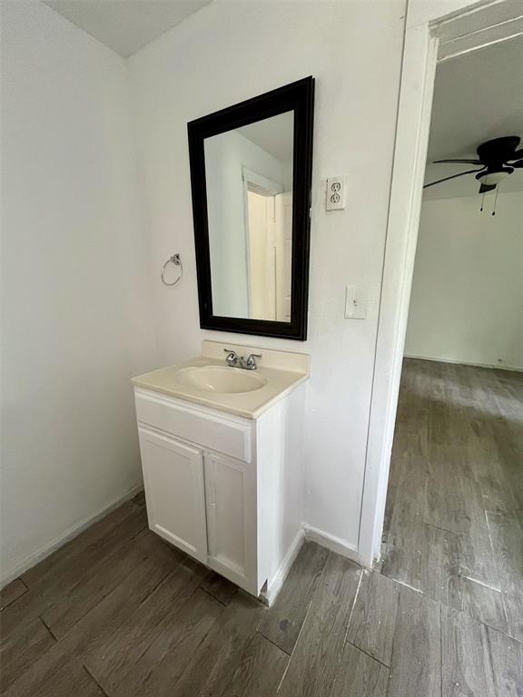 1037 Cedar Street Paris, TX 75460 - Photo 11 of 13 a bathroom with a sink and a mirror