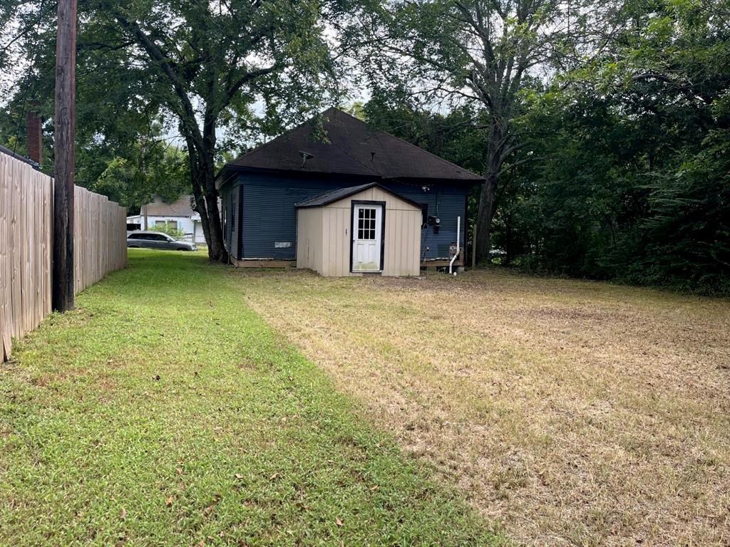 1037 Cedar Street Paris, TX 75460 - Photo 13 of 13 a house with a tree in front of the house