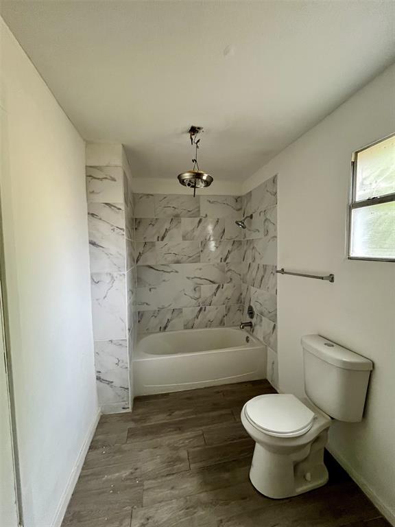 1037 Cedar Street Paris, TX 75460 - Photo 10 of 13 a bathroom with a toilet and a shower