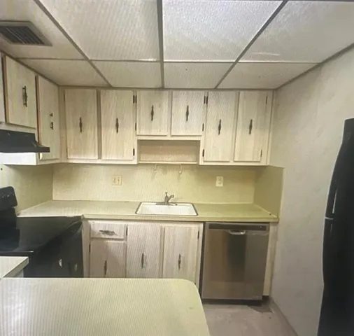 a kitchen with stainless steel appliances a sink stove and cabinets