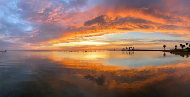 a view of a balcony with chairs and wooden floor