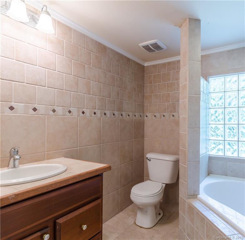 2904 Tuckaseegee Road Charlotte, NC 28208 - Photo 17 of 21 a bathroom with a sink a toilet and bathtub