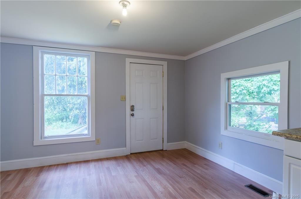 2904 Tuckaseegee Road Charlotte, NC 28208 - Photo 20 of 21 a view of an empty room with wooden floor and a window