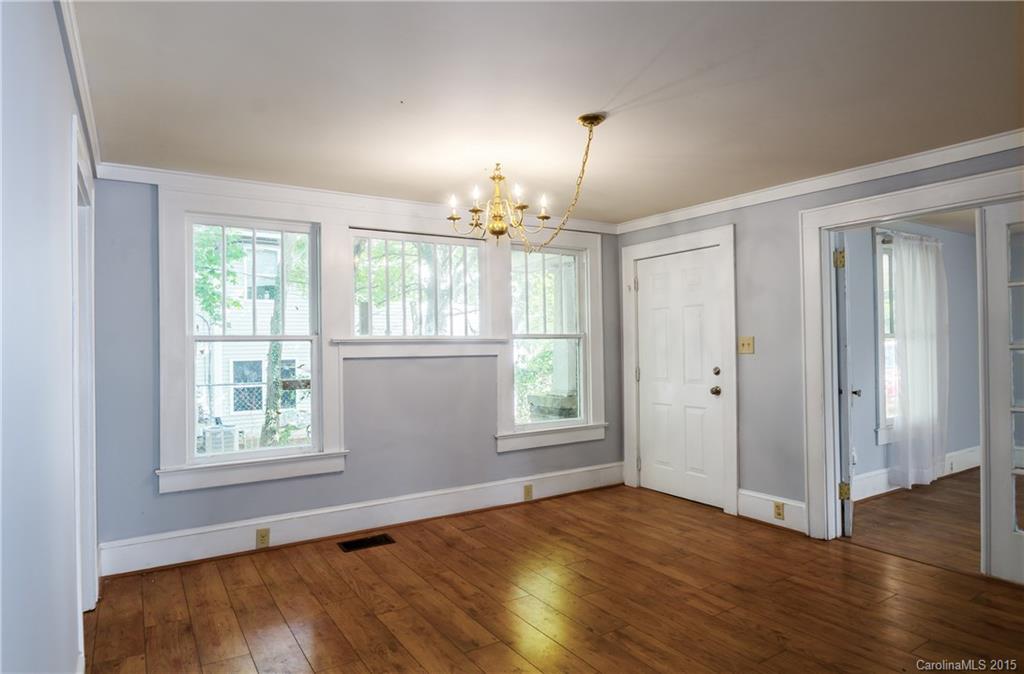 2904 Tuckaseegee Road Charlotte, NC 28208 - Photo 5 of 21 an empty room with wooden floor chandelier and windows