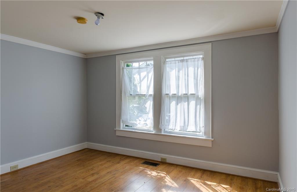 2904 Tuckaseegee Road Charlotte, NC 28208 - Photo 7 of 21 a view of an empty room with wooden floor and a window