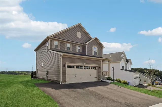 a front view of a house with a garden