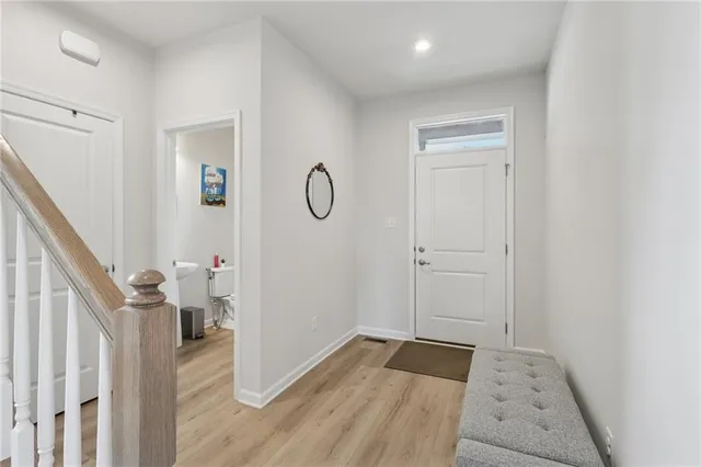 a view of a livingroom with wooden floor and white doors