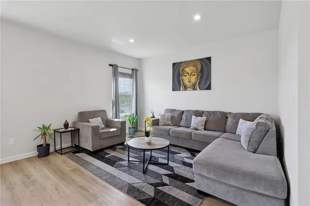 a living room with furniture and wooden floor