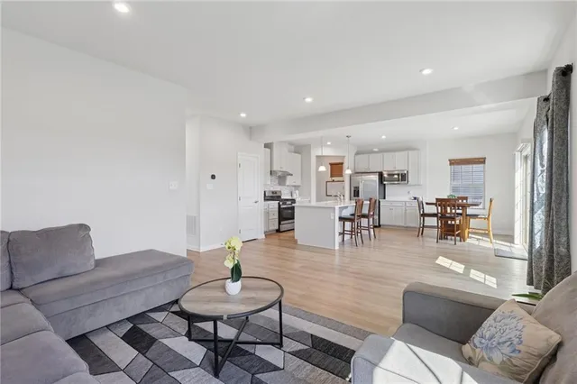 a living room with furniture and wooden floor