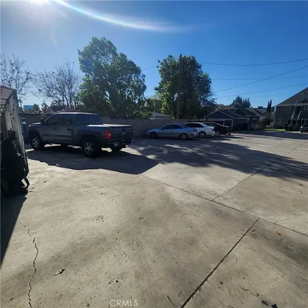 a view of backyard with car parked