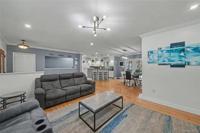 a living room with furniture and kitchen view