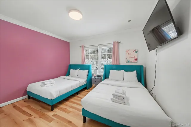 a bedroom with a bed and flat screen tv