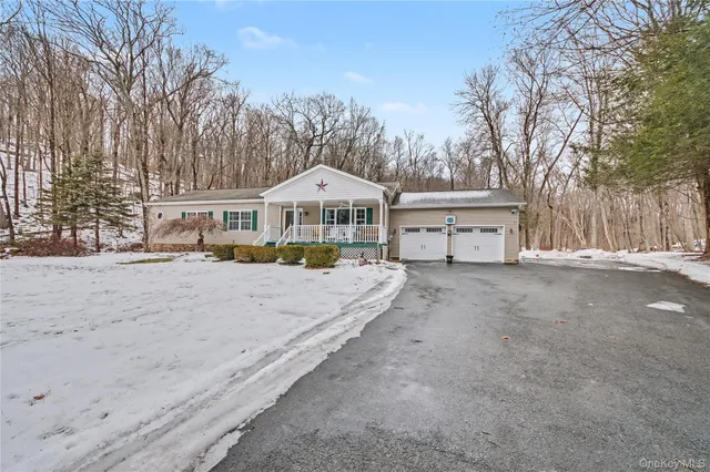 a view of a white house with a yard covered in snow