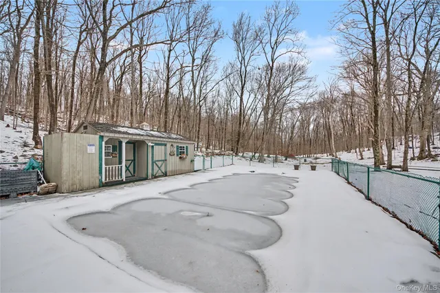 a view of a white house with a yard covered in snow