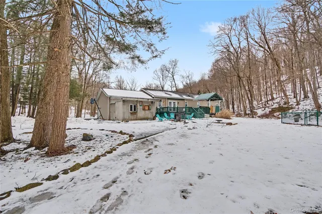 a view of a house with a yard covered in snow