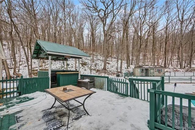 a table and chairs with the trees in the front