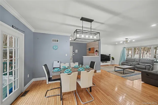a view of a dining room with furniture window and wooden floor