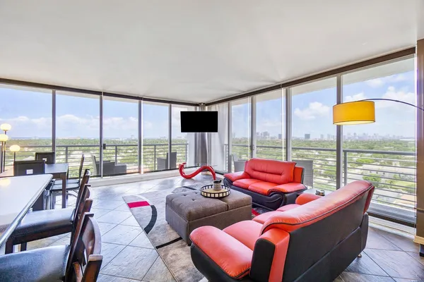 a living room with furniture and a large window