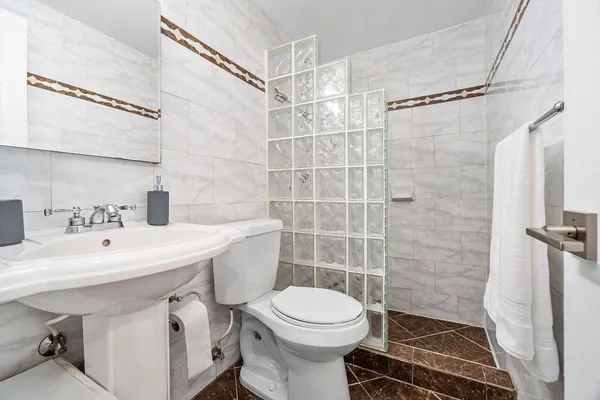 a bathroom with a sink toilet and shower