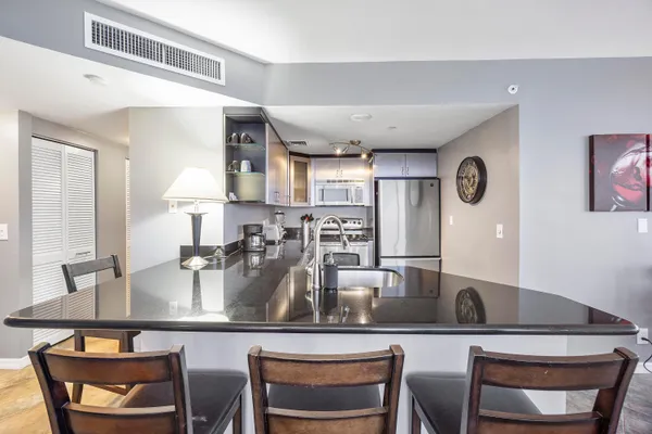 a kitchen with a table chairs and microwave