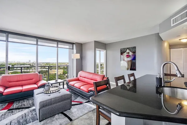 a living room with furniture city view and large windows