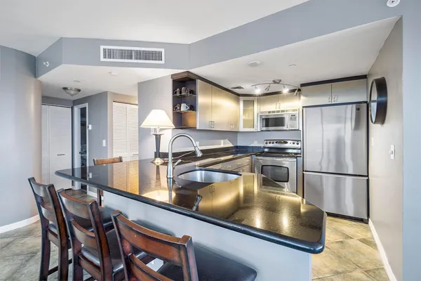 a kitchen with a sink appliances and a counter top space