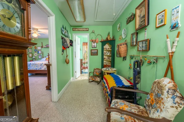 a bedroom with a bed a bookshelf and a window