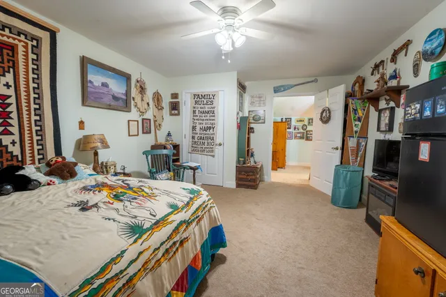 a bedroom with bed and a furniture