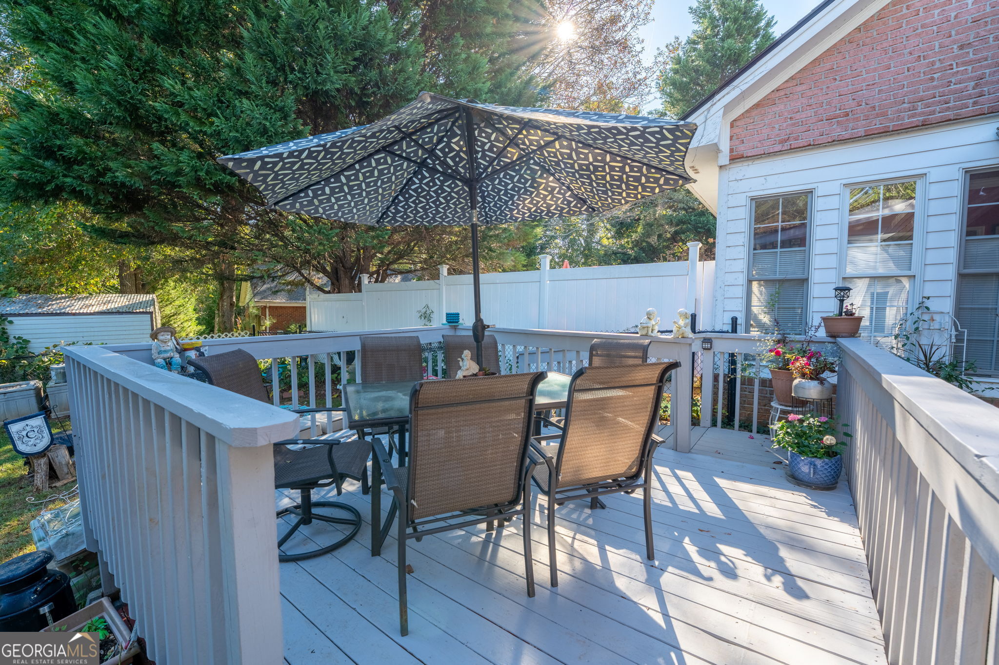 50 Green Hill Place Toccoa, GA 30577 - Photo 35 of 38 a patio with wooden floor a yard a table and chairs