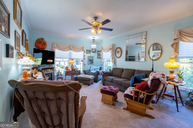 a living room with fireplace furniture and a chandelier