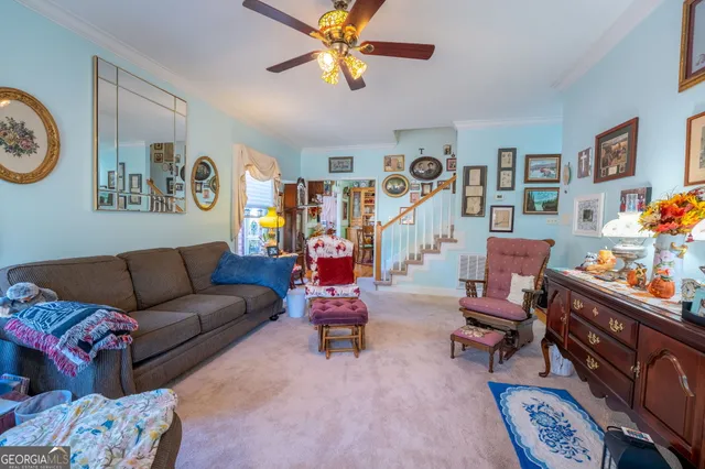 a living room with furniture and paintings on the wall