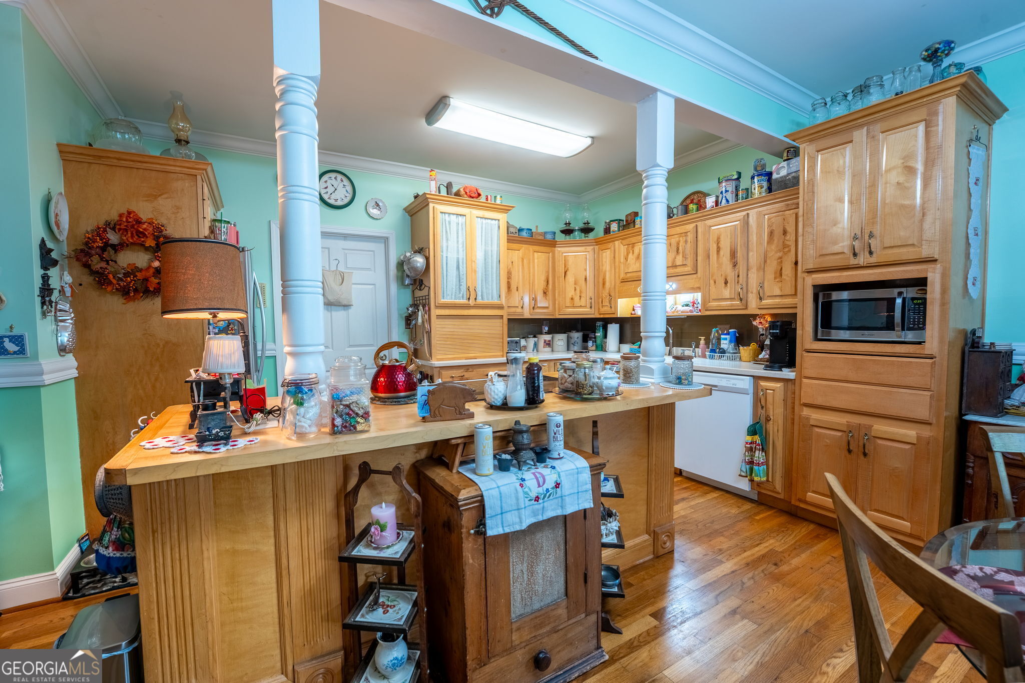 50 Green Hill Place Toccoa, GA 30577 - Photo 9 of 38 a kitchen with a refrigerator a stove a sink dishwasher and a fireplace with wooden floor