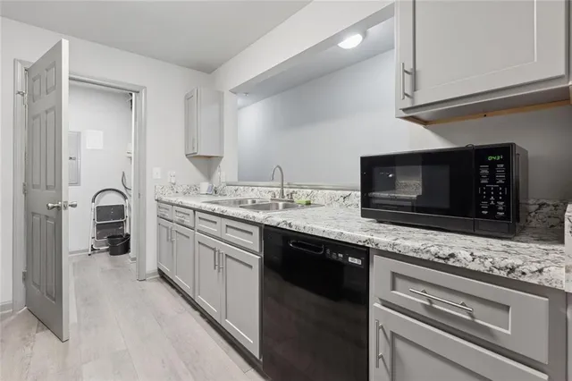 a kitchen with stainless steel appliances granite countertop a sink and a stove