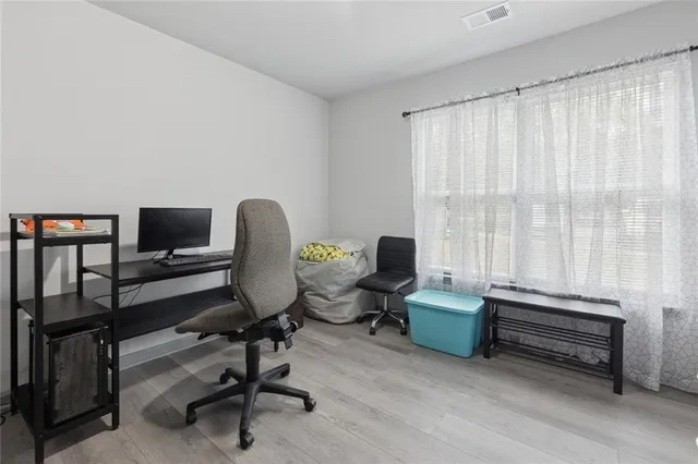 a view of a workspace with furniture and a window