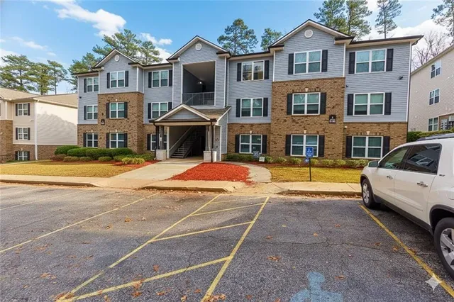 a view of a white house with a swimming pool