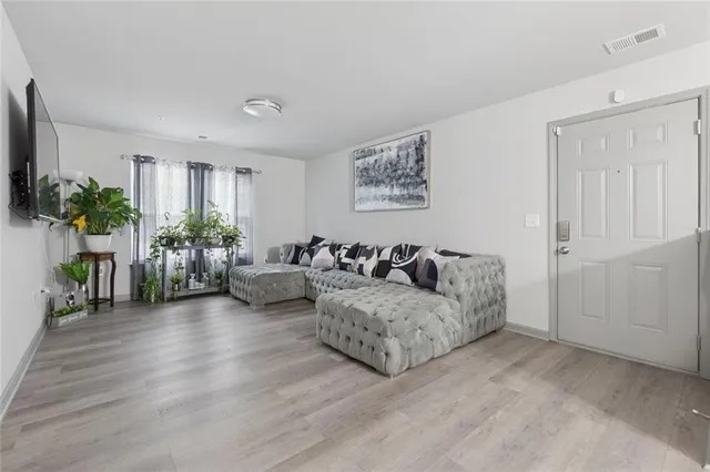 a living room with furniture and a potted plant