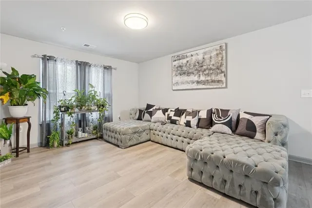a living room with furniture potted plant and a window