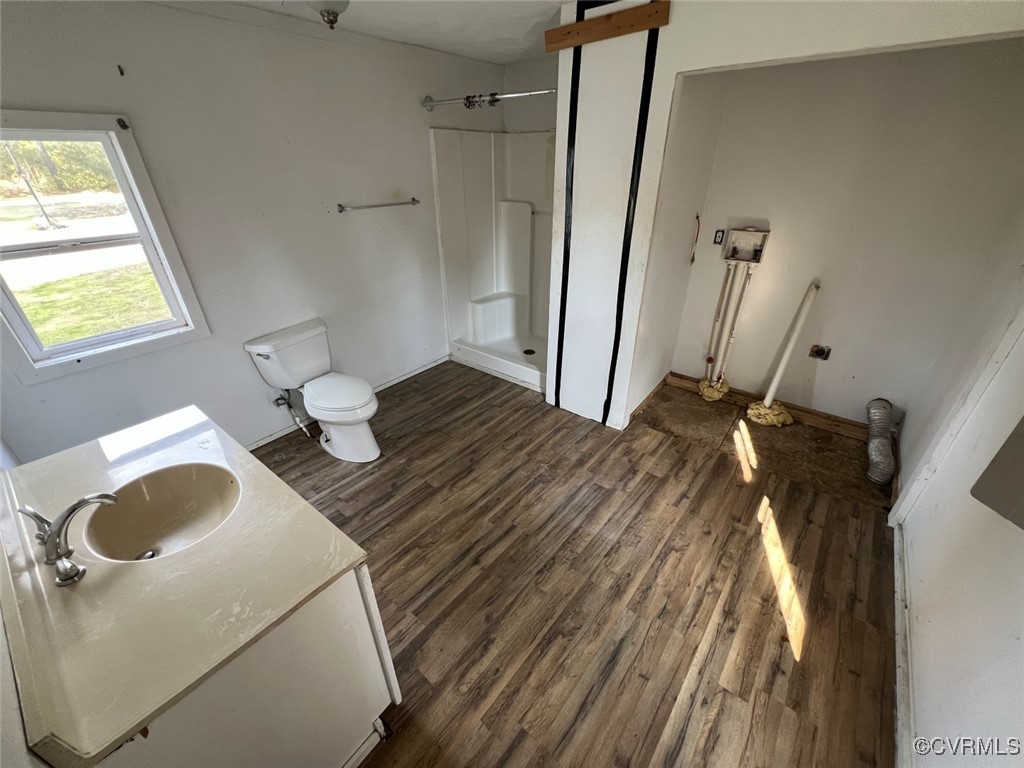 2307 New Point Comfort Highway Mathews, VA 23109 - Photo 11 of 20 a bedroom with a bed and a wooden floor