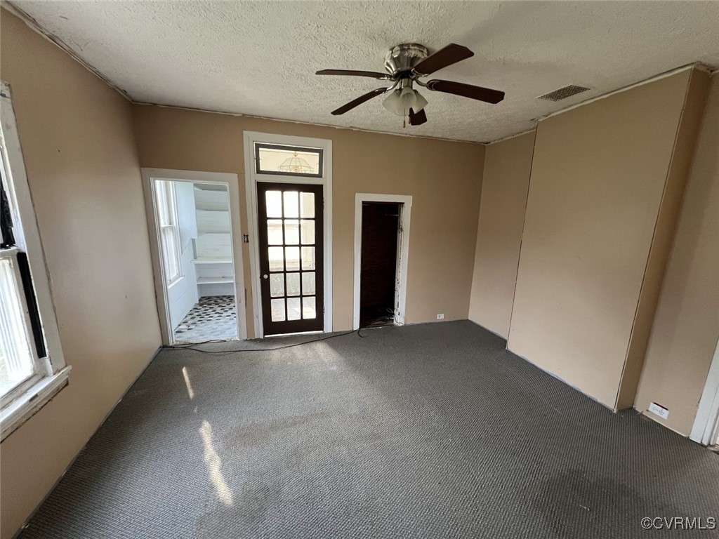 2307 New Point Comfort Highway Mathews, VA 23109 - Photo 12 of 20 an empty room with chandelier fan and windows