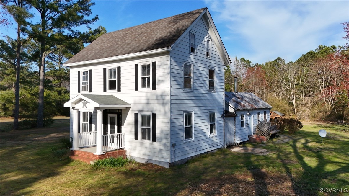 2307 New Point Comfort Highway Mathews, VA 23109 - Photo 2 of 20 a front view of a house with a yard and balcony