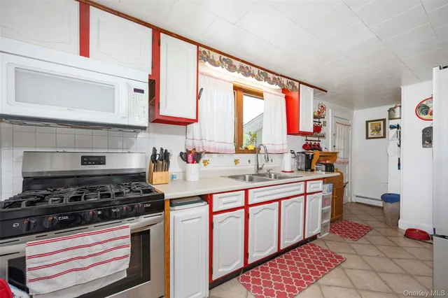 a kitchen with stainless steel appliances a stove a sink and cabinets
