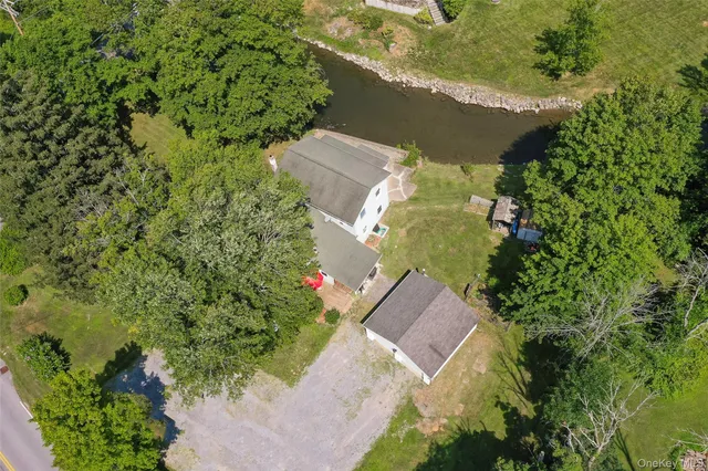 an aerial view of a house with a yard