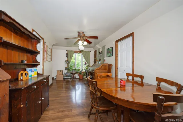 a dining room with furniture and wooden floor