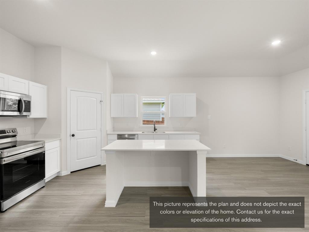 1813 Zelvia Lane Waco, TX 76708 - Photo 13 of 24 a view of kitchen with sink wooden floor and living room