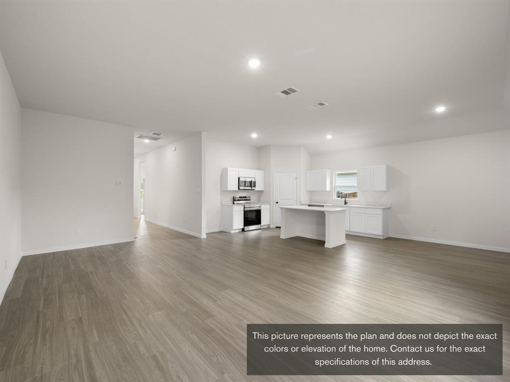 1813 Zelvia Lane Waco, TX 76708 - Photo 14 of 24 a view of kitchen with kitchen island wooden floors and stainless steel appliances