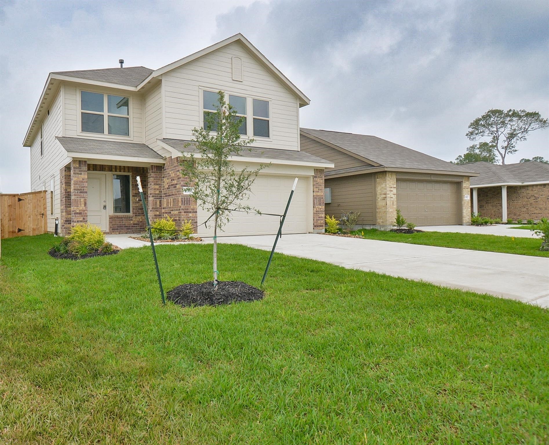 18566 Cepagatti Drive New Caney, TX 77357 - Photo 1 of 35 a view of a house with a yard and a garden