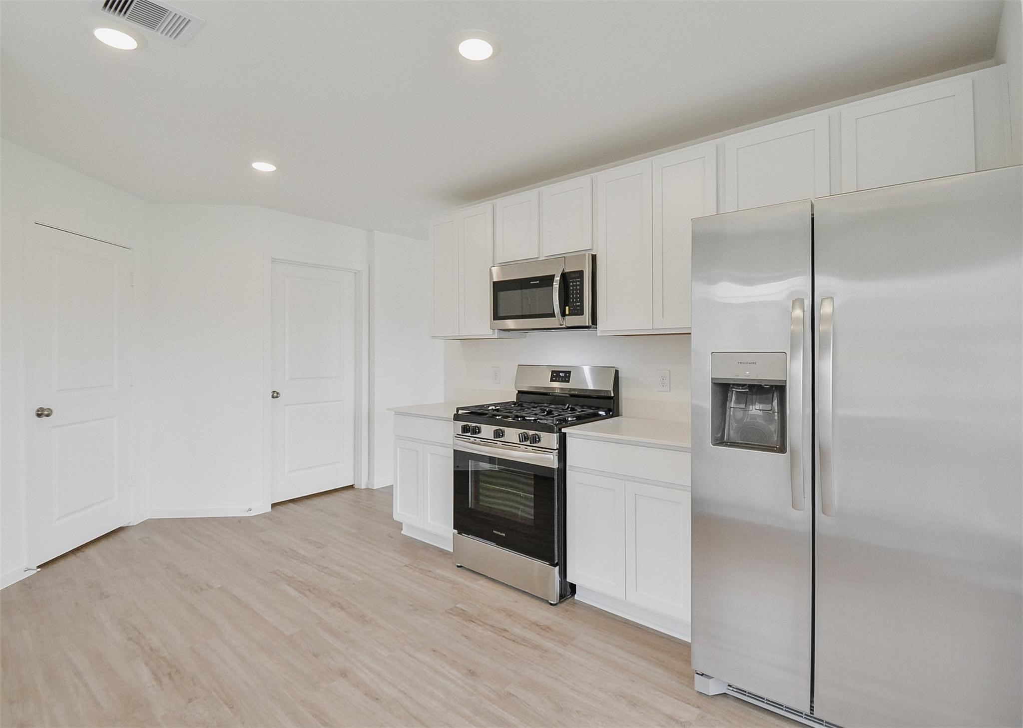 18566 Cepagatti Drive New Caney, TX 77357 - Photo 11 of 35 a kitchen with a refrigerator stove and microwave