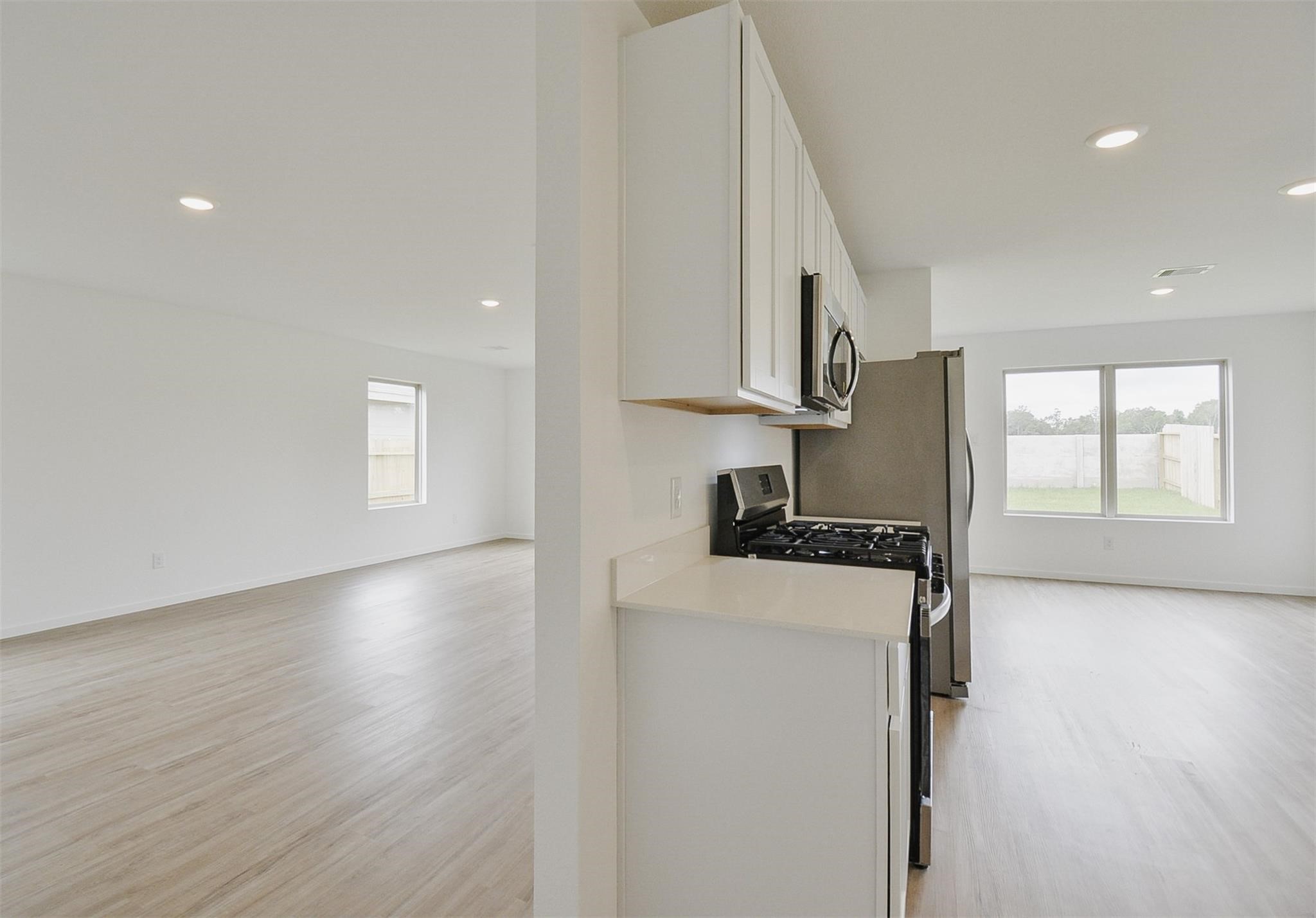 18566 Cepagatti Drive New Caney, TX 77357 - Photo 15 of 35 a kitchen with a stove a sink and a refrigerator
