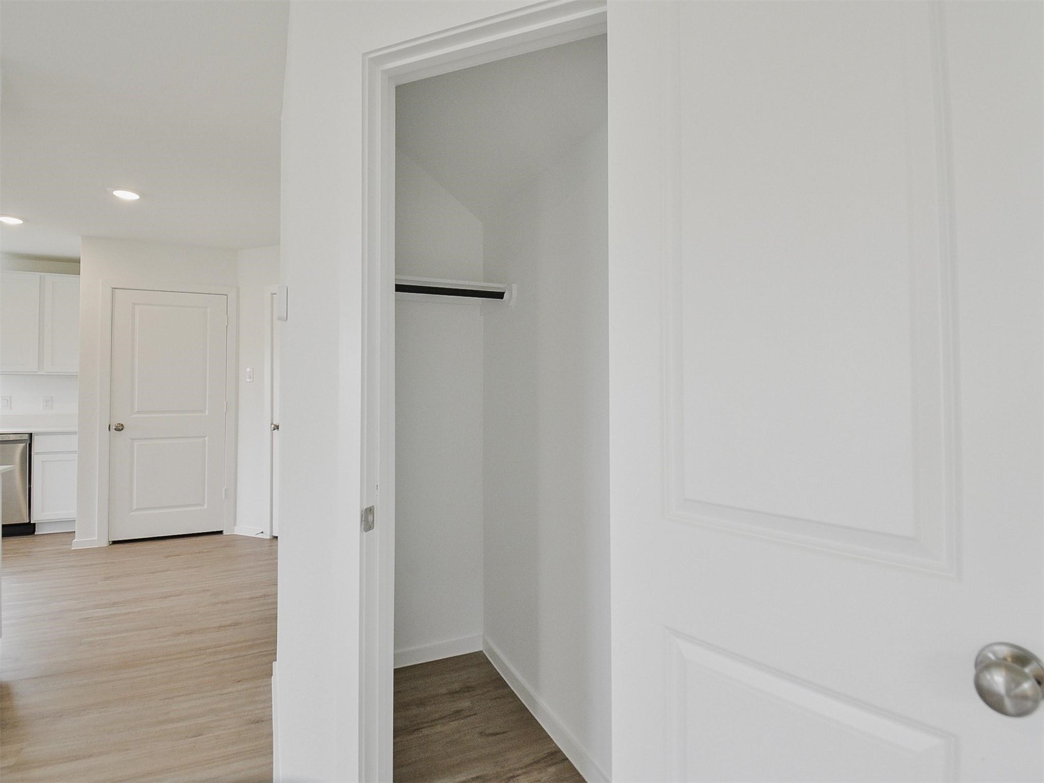 18566 Cepagatti Drive New Caney, TX 77357 - Photo 17 of 35 a view of a hallway with wooden floor